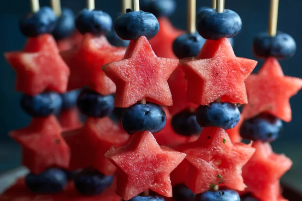 Easy Patriotic Fruit Kabob Skewers arranged on white plate